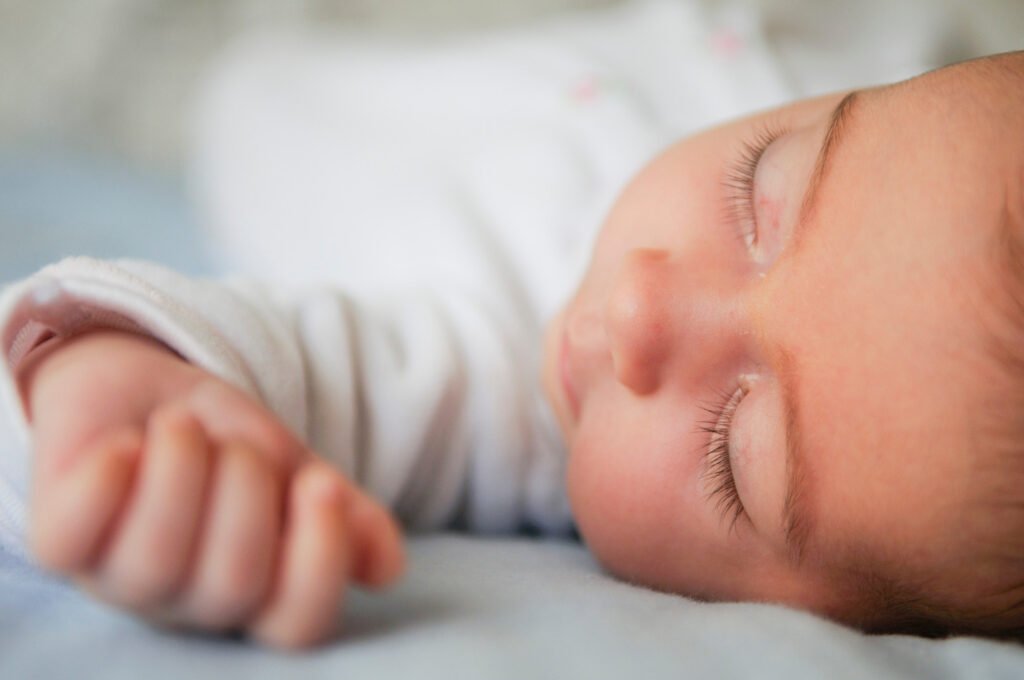 Baby sleeping peacefully during a sleep regression. Learn the signs, causes and how to support your baby's sleep with gentle, evidence-based advice.