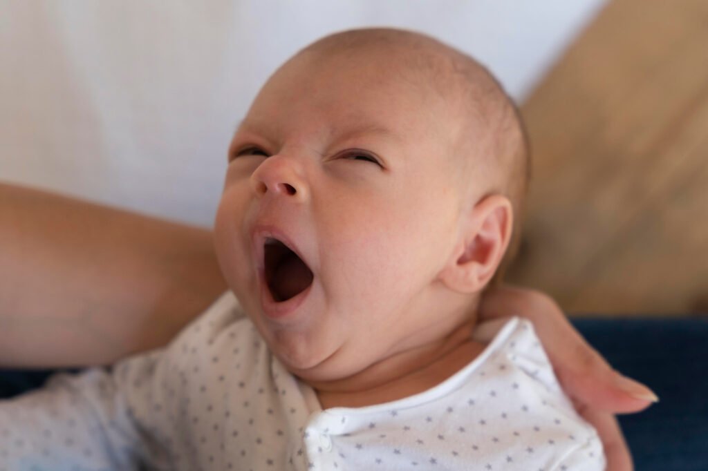 Yawning baby showing signs of tiredness. white noise for babies.
