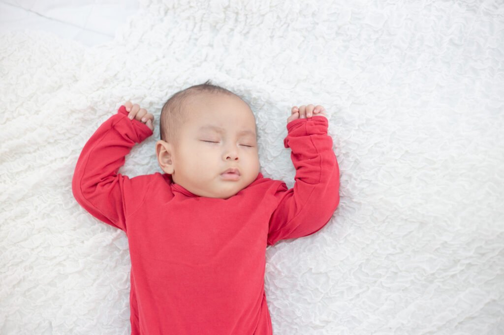 Baby sleeping peacefully on their back in a safe sleep position-child only falls asleep with me