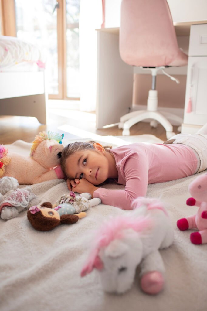 Young child sleeping peacefully after a daytime nap during the transition away from naps.